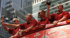 Stan Bowman (third from the left) alongside fellow Blackhawks executives John McDonough, Jay Blunk, and Al MacIsaac in June 2010. Blackhawks-2010-parade-mgmt-crop.png