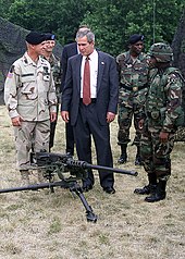 Ellis and U.S. President George W. Bush witness a demonstration of the M2 Browning machine gun in July 2002. Bush and M2.JPEG