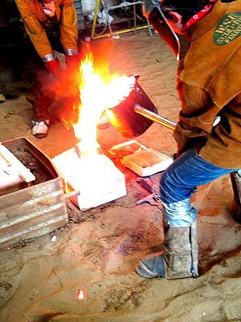 Sand mold casting with iron.