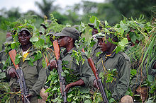 Congolese soldiers being trained by American contractors wait for instructions during training at Camp Base, Kisangani, 5 May 2010 Congolese Light Infantry Battalion training at Camp Base, Kisangani 2010-05-05 1.JPG