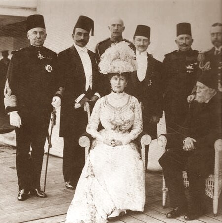 Ziyaeddin (standing third from right) aboard HMS Medina at Port Said in December 1911, during a stopover of the ship bringing King George V and Queen 