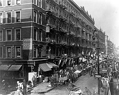Lower East Side in 1909. He said he never forgot his childhood years when he slept under tenement steps, ate scraps, wore secondhand clothes and sold newspapers. "Every man should have a Lower East Side in his life," said Berlin. HD.11.040 (10995684853).jpg