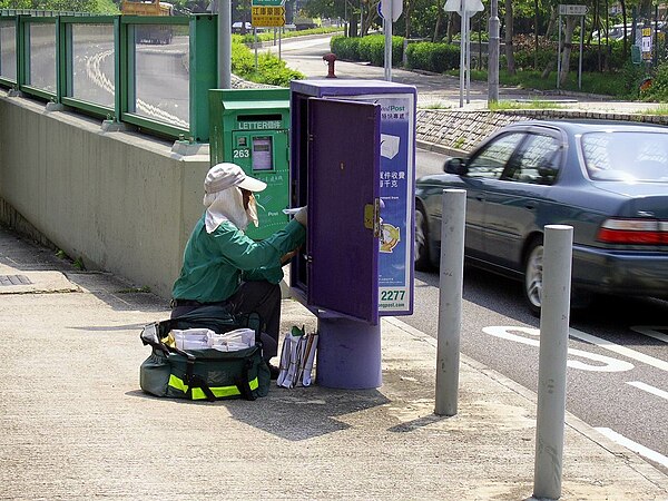 A postman collecting mail for delivery