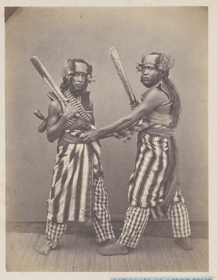 Baris demang dancers in Singaraja (1865-1866); photo by Isidore van Kinsbergen KITLV 4396 - Isidore van Kinsbergen - Bald Head Dancers (baris demang) of Boeleleng at Singaraja - 1865-1866.tif