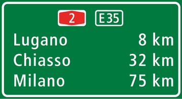The image shows a highway sign with the Frutiger typeface.