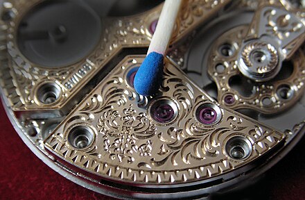 At an engravers workshop: Miniature engraving on a Louis George watch movement: Smallest engraving of the royal Prussian eagle on a watch movement. It takes about 100 passes to create the figure.