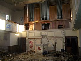 The vandalised interior in early 2016, before the fire, showing the original organ Loxley chapel interior.jpg