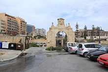 One of the arches to the palace, now leads to a car park, with the main arch seen far to the left Malta - St. Julian's - Triq il-Wilga 02 ies.jpg