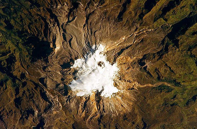Nevado del Ruiz seen from space. The summit ice cap and glaciers surround the dark Arenas crater.