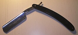 A straight razor with an oversized (and rare) round point 8/8” blade with plastic handle. The etching is very poor quality and the faint Best Brand logo indicates a generic Asian import. Some corrosion is apparent on the blade at the lower end of the shoulder, near the heel. The tang is very short compared to the size of the big blade and therefore indicates poor design. The main advantage of such a large blade size is that it can carry lots of lather through multiple successive shaving strokes and it does not have to be rinsed as often as a smaller sized blade, if at all, for a complete shave