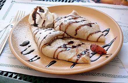 Gundel palacsinta filled with nuts and chocolate sauce.