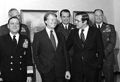 Secretary of Defense Donald Rumsfeld with President-Elect Jimmy Carter and Chairman of the Joint Chiefs of Staff General George S. Brown and the other members of the Joint Chiefs of Staff during a tour at The Pentagon on December 17, 1976.