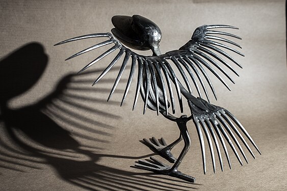 sculpture by Jean Stratonovitch of a prehistoric bird made of weldered silverware