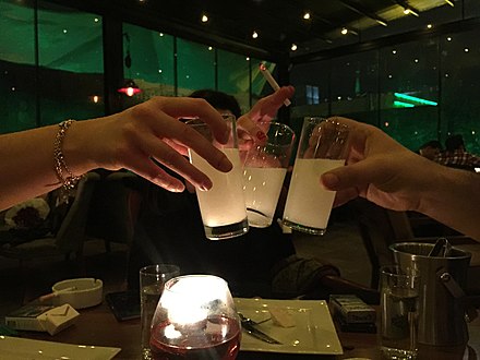 A toast with raki. The clear spirit becomes cloudy when water is added