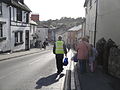 Southern Vectis staff, walking bus passengers through the High Street, Brading, Isle of Wight. At the time, roadworks were taking place in Brading High Street, meaning it was closed to traffic completely. Southern Vectis routes 2 and 3 towards Ryde terminated at the Bull Ring, whilst at Brading Church, shuttle bus services operated to Tesco and Ryde. Staff from Southern Vectis walked the passengers to connect the two services, and as can be seen here, also helped out with bags.