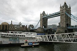 A cruise boat departs from Tower Bridge Quay