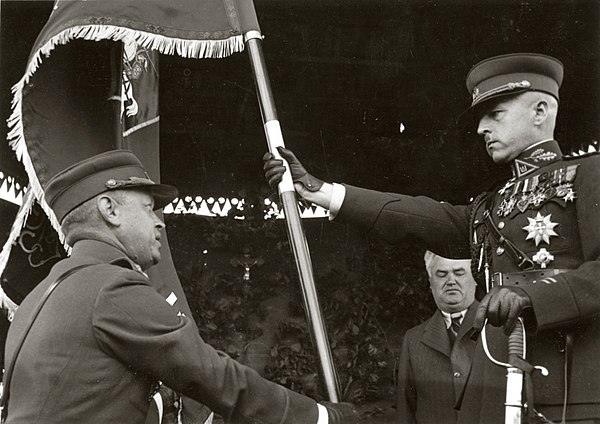 Raštikis with the Lithuanian Armed Forces flag during a ceremony in 1939