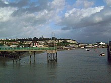 Frindsbury Church stood on a hill overlooking the Medway. The hill has been extensively quarried leaving the distinctive cliffs. To the left of the church is Church Green. Directly in front of it is Strood Pier and the entrance to the Strood basin. To the right is the Frindsbury Peninsula, and the Phoenix Wharf and Lower Curel's Yard.