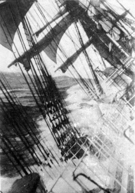 Sailing ship rounding Cape Horn.