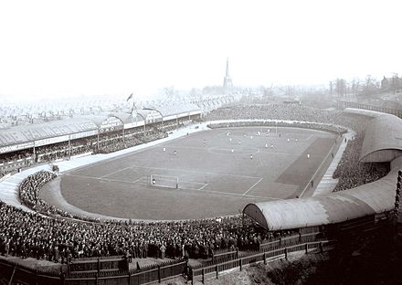 Villa Park during a match against Liverpool in 1907; the ground is yet to be squared off, and the cycle track can still be seen.