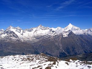 Zinalrothorn (center) between Ober Gabelhorn (left) and Weisshorn (right) of the Weisshorn group, seen from Gornergrat, to the left of Ober Gabelhorn the tip of Dent Blanche is visible