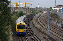 A London Overground Watford DC Line service departs Willesden for Watford Junction. There are three trains per hour in each direction on this line, operated using Class 710 electric multiple units since 2019 Willesden Junction station MMB 28 378228.jpg