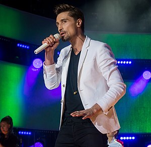 Dima Bilan performing with hand mic in 2016.