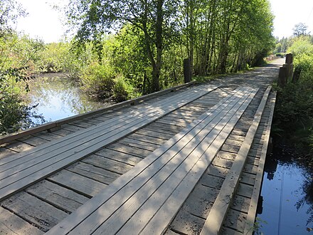 The new wooden bridge over Big Beef Creek at approximately river mile 7.9 amidst an unnamed marsh at NW Turnstone Lane, Kitsap County, Washington, 15 August 2016