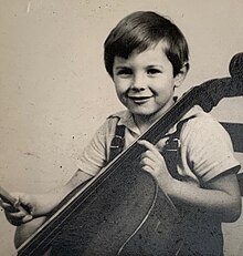 Bochmann aged around eight, playing the cello
