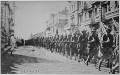 American troops in Vladivostok parading before the building occupied by the staff of the Czecho-Slovaks. Japanese marines are standing at attention as they march by. Siberia, August 1918. Underwood and Underwood. - NARA - 533750.gif