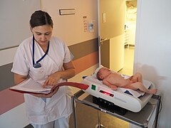 A newborn being weighed after birth. Birth weight is the body weight of a baby at birth. Baby weight Necker 2014.jpg