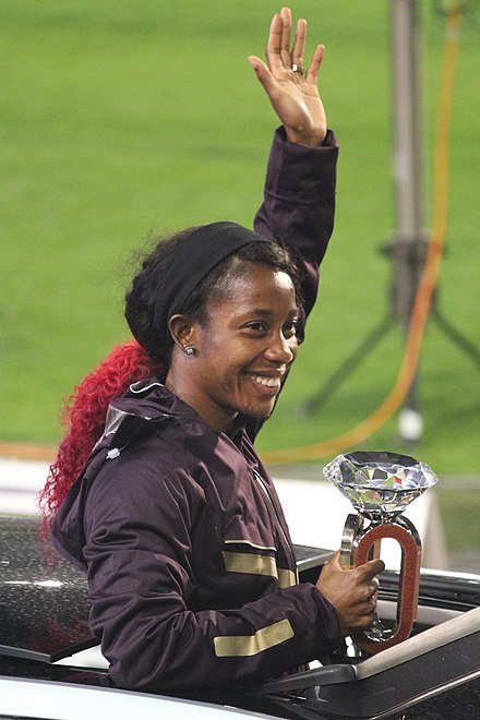 Fraser-Pryce with her Diamond League trophy in 2013. She has won the trophy five times: once in the 200 m (2013) and a record four times in the 100 m (2012, 2013, 2015 and 2022).[241]
