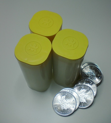 Three 25-coin tubes together with seven coins Canadian Silver Maple Leaf coins and tubes.png