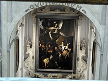 La tela del Caravaggio vista dal balconcino della sala del Coretto, al primo piano del palazzo