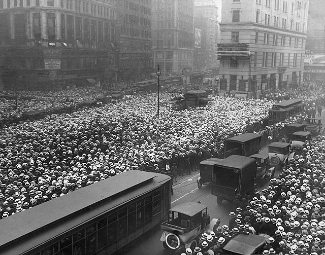 A crowd outside One Times Square follows the progress of the Jack Dempsey vs. Georges Carpentier boxing fight in 1921.