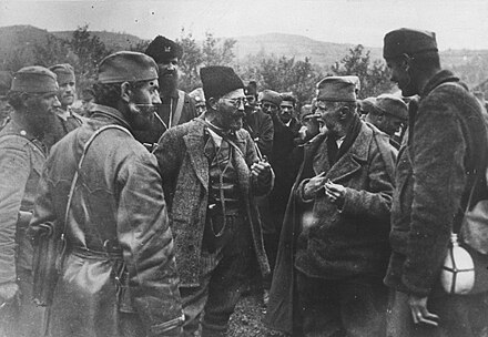 Draža Mihailović (centre with glasses) confers with his principal political adviser Dragiša Vasić (second from right) and others in 1943