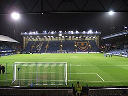 The Fratton End in 2008. Former player-manager Jimmy Dickinson is remembered in the seating design.