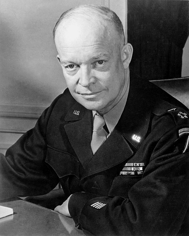 A portrait of a mostly-bald Dwight D. Eisenhower in uniform looking directly at the camera