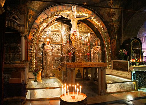 The Altar of the Crucifixion, where the rock of Calvary is encased in protective glass