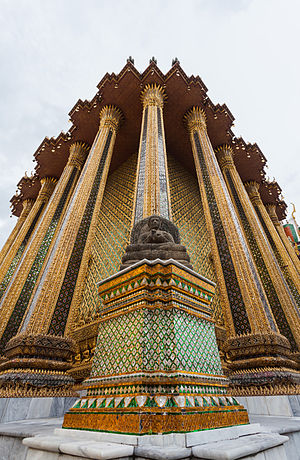 Exterior columns and one of the four replica Borobodur-style Buddha images at the corner of The Library (Phra Mondop), building belonging to the Temple of the Emerald Buddha (Wat Phra Kaew), Bangkok, Thailand