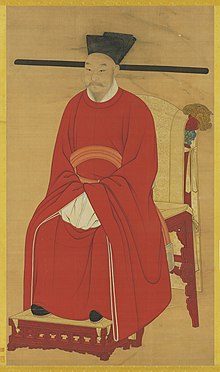 císař Kuang-cung sedící na trůnu