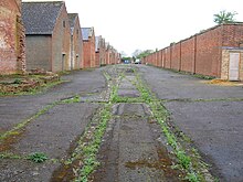 Alternating magazine and traverse buildings (left) inside the boundary wall (right) at Weedon Bec Gunpowder magazines, Weedon Bec - geograph.org.uk - 1405645.jpg