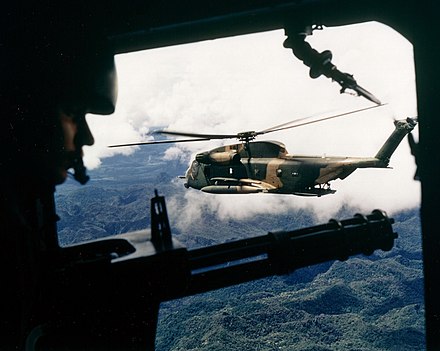 A HH-53 seen from the gunner's position of a helicopter over Vietnam in October 1972