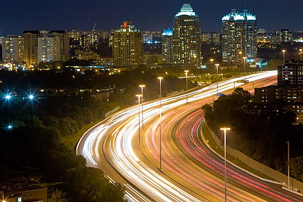 Highway lighting can have a negative influence on those living close to the freeway. High-mast lighting is an alternative as it concentrates the light on the road, but the tall structures can also lead to a NIMBY effect. Seen here is Ontario Highway 401 through suburban Toronto.