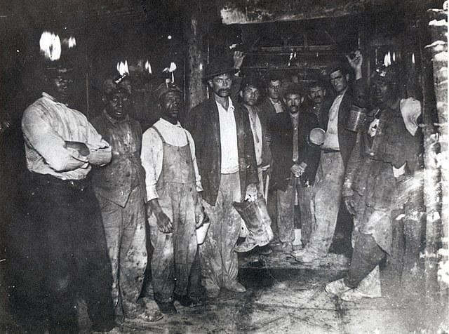 Italian and African-American clay miners in mine shaft, 1910