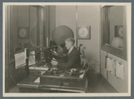 KOAC announcer broadcasting from the studios in Covell Hall at Oregon State University (1929). Koac-announcer.png