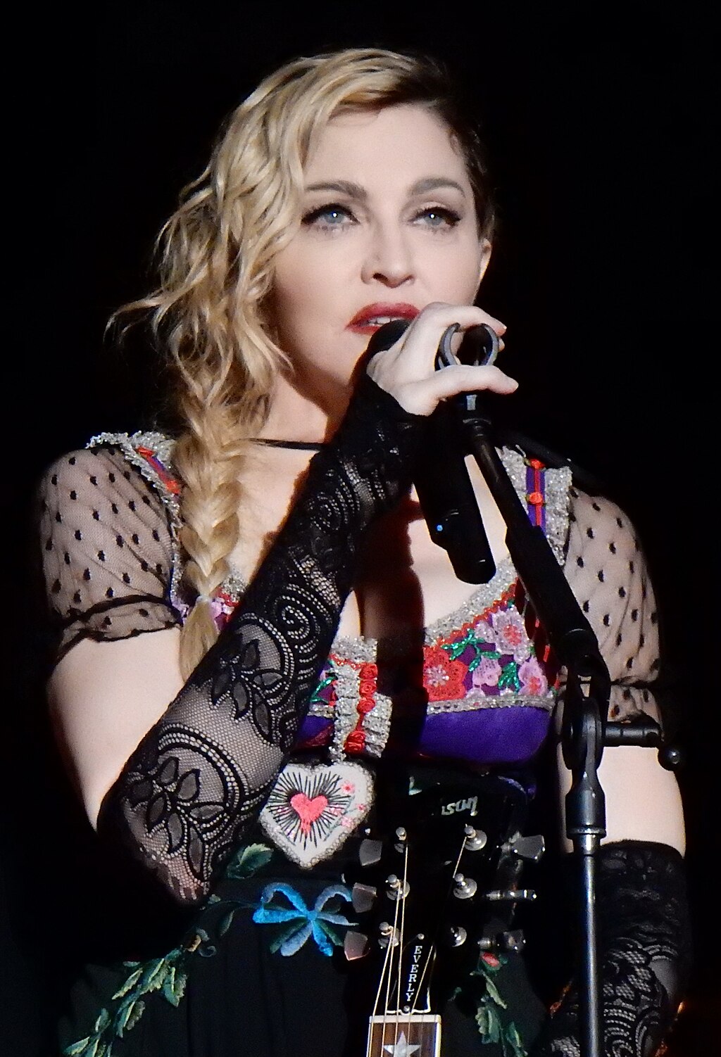 Madonna standing in front of a microphone