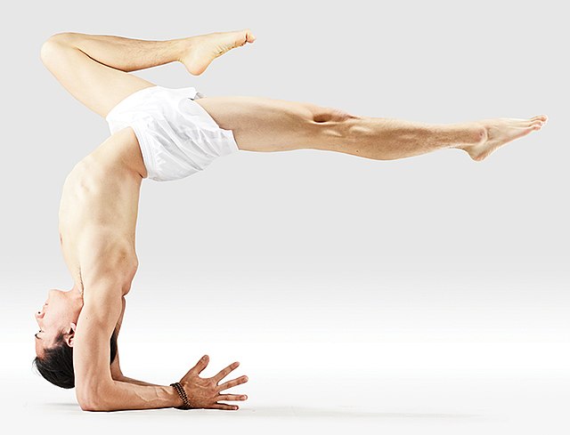 caucasian man scorpion pose Vrschikasana gymnastic acrobatics isolated  studio on white background Stock Photo - Alamy
