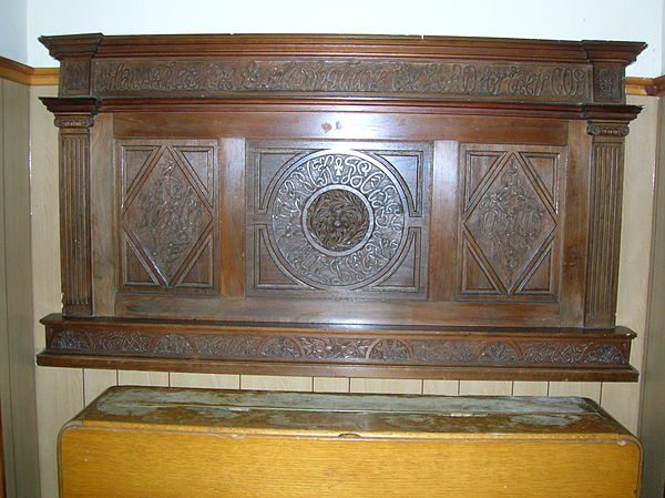 A highly carved mantelpiece in Gateside Memorial Hall.