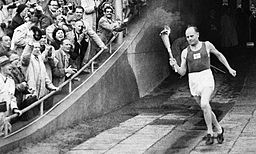 Paavo Nurmi enters the Olympic Stadium in 1952